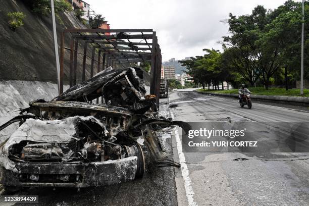 View of burnt trucks used to block a highway by alleged criminal gangs during clashes with the police at the Cota 905 neighborhood in Caracas, on...