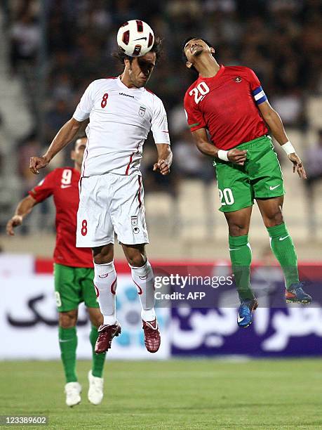 Iran's Ali Karimi jumps with Indonesia's Bambang Pamungkas to head the ball during their 2014 World Cup Asian zone qualifying football match at Azadi...