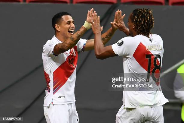 Peru's Yoshimar Yotun celebrates with teammate Andre Carrillo after scoring against Colombia during their Conmebol 2021 Copa America football...