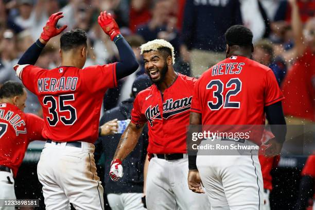 Bobby Bradley of the Cleveland Indians celebrates with Franmil Reyes and Oscar Mercado after hitting a game winning solo home run off Jake Brentz of...