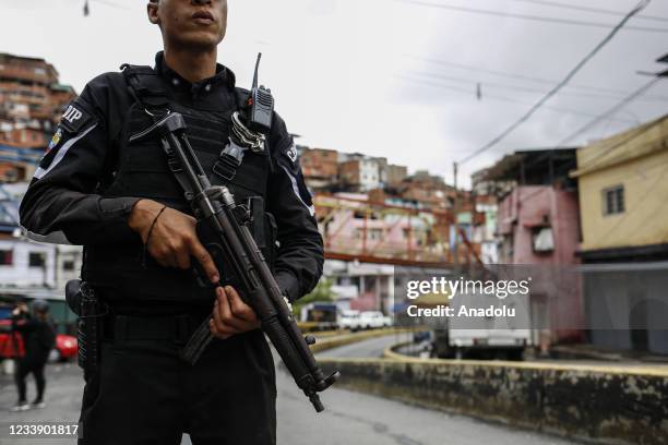 Members of a special unit of the National Police set up an alcabala in one of the main streets of the Cota 905 neighborhood after three days of...