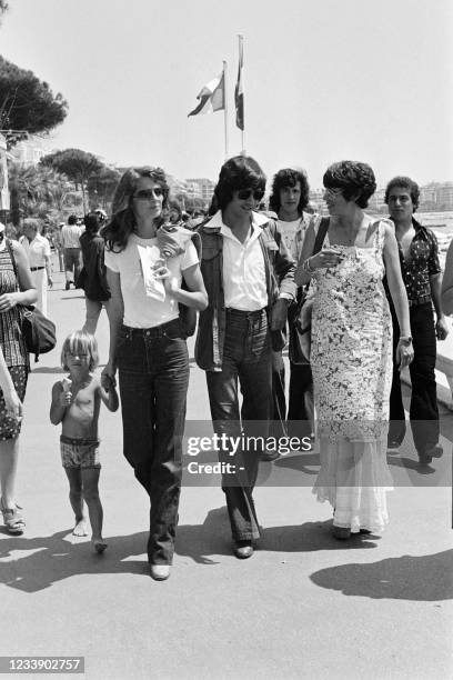 British actress and member of the jury Charlotte Rampling walks on the Croisette with her husband New Zealander actor Bryan Southcombe and their son...