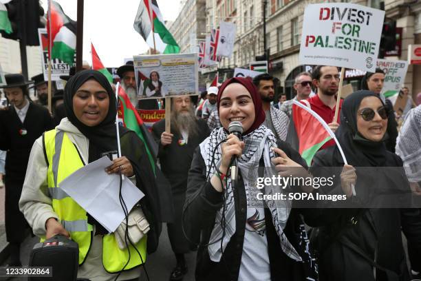 Protesters uses a microphone to put her message across during the protest. Students and other protesters go on a tour of London Universities to...