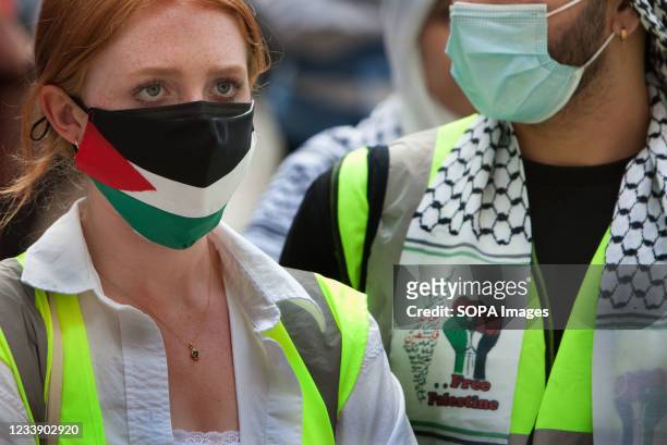 Protester seen wearing a Palestinian flag face mask and another a free Palestine scarf during the protest. Students and other protesters go on a tour...