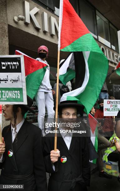 Protesters from the orthodox Jewish anti-Zionist group the Neturei Karta hold Palestinian flags and placards outside King's College during a protest....