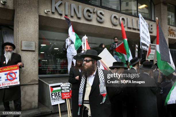 Protesters from the orthodox Jewish anti-Zionist group the Neturei Karta hold Palestinian flags and placards outside King's College during a protest....