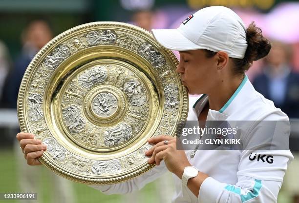 Australia's Ashleigh Barty holds the winner's Venus Rosewater Dish trophy after winning her women's singles match against Czech Republic's Karolina...