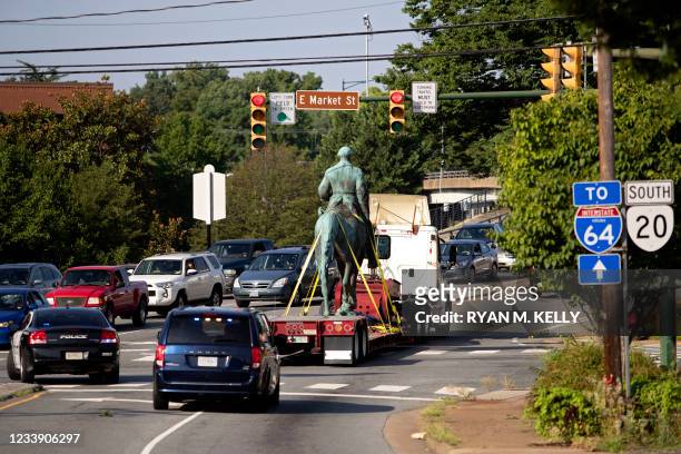 The statue of Confederate General Robert E. Lee is driven away from a park after being removed in Charlottesville, Virginia on July 10, 2021. - The...