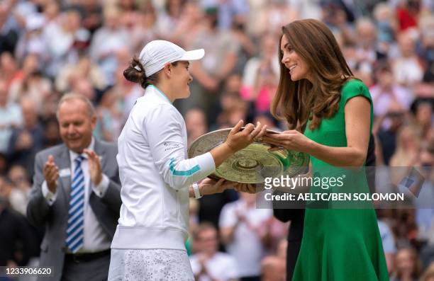 Australia's Ashleigh Barty receives the trophy from Britain's Catherine, Duchess of Cambridge, after defeating Czech Republic's Karolina Pliskova...