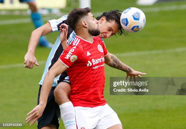 Pedro Geromel of Gremio and Yuri Alberto of Internacional fight for the ball during the match between Gremio and Internacional as part of Brasileirao...
