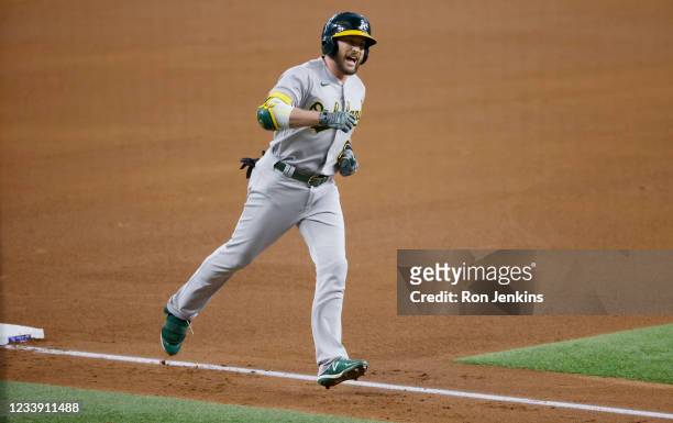Jed Lowrie of the Oakland Athletics reacts after hitting a solo home run against the Texas Rangers during the fourth inning at Globe Life Field on...