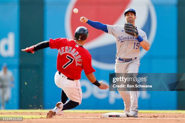 Whit Merrifield of the Kansas City Royals forces out Cesar Hernandez of the Cleveland Indians at second base and throws out Jose Ramirez at first...