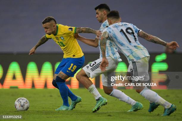 Brazil's Everton is marked by Argentina's Cristian Romero and Nicolas Otamendi during the Conmebol 2021 Copa America football tournament final match...