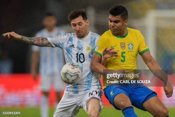 Argentina's Lionel Messi and Brazil's Casemiro vie for the ball during the Conmebol 2021 Copa America football tournament final match at Maracana...