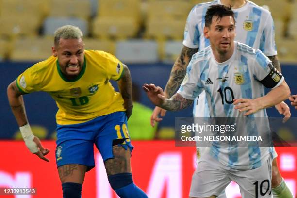 Brazil's Neymar grimaces next to Argentina's Lionel Messi during the Conmebol 2021 Copa America football tournament final match at Maracana Stadium...