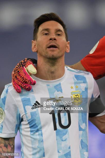 Argentina's Lionel Messi sings his national anthem before the start of the Conmebol 2021 Copa America football tournament final match against Brazil...