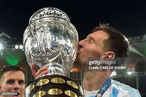 Argentina's Lionel Messi kisses the trophy after winning the Conmebol 2021 Copa America football tournament final match against Brazil at Maracana...