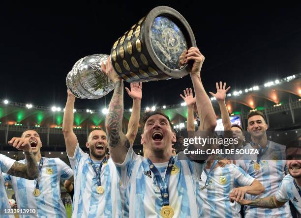 Argentina's Lionel Messi holds the trophy as he celebrates with teammates after winning the Conmebol 2021 Copa America football tournament final...