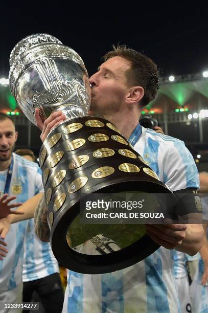 Argentina's Lionel Messi kisses the trophy after winning the Conmebol 2021 Copa America football tournament final match against Brazil at Maracana...