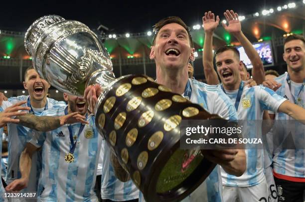 Argentina's Lionel Messi holds the trophy as he celebrates with teammates after winning the Conmebol 2021 Copa America football tournament final...