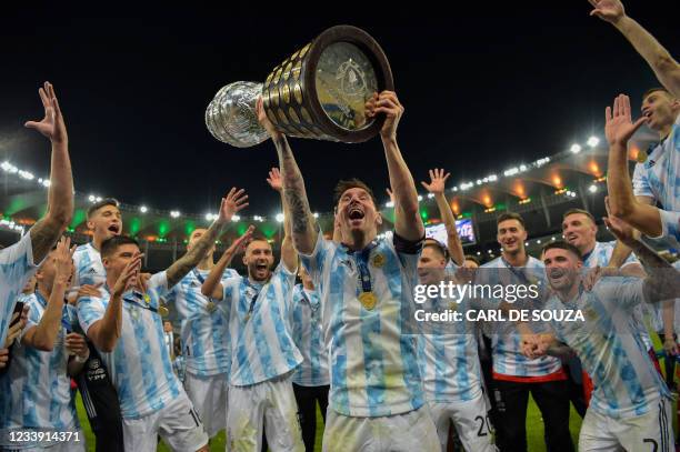 Argentina's Lionel Messi holds the trophy as he celebrates with teammates after winning the Conmebol 2021 Copa America football tournament final...