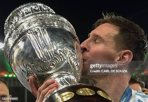 Argentina's Lionel Messi kisses the trophy after winning the Conmebol 2021 Copa America football tournament final match against Brazil at Maracana...