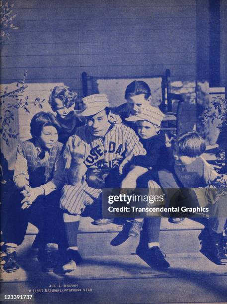 Movie star Joe E. Brown poses in his baseball uniform with co-stars George Ernest, Dickie Moore, Ginger Connolly and others, on the set of the First...