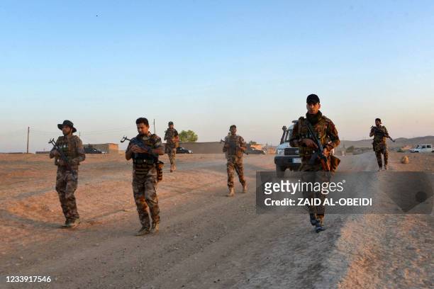 Iraqi forces patrol during military operations in the south and west of the northern Iraqi city of Mosul in search of Islamic State militants, on...