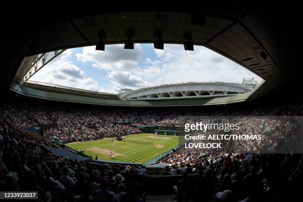 Spectators watch on a full capacity Centre Court as Serbia's Novak Djokovic returns to Italy's Matteo Berrettini during their men's singles final...