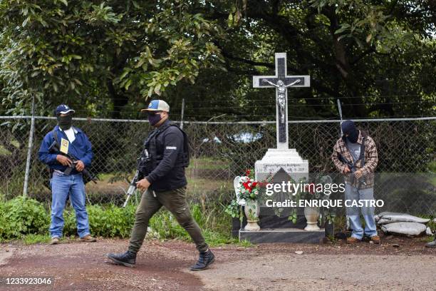 Members of the self-defense group Pueblos Unidos carry out guard duties in protection of avocado plantations, whipped by drug cartels that dominate...