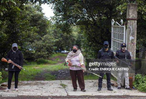 Members of the self-defense group Pueblos Unidos carry out guard duties in protection of avocado plantations, whipped by drug cartels that dominate...