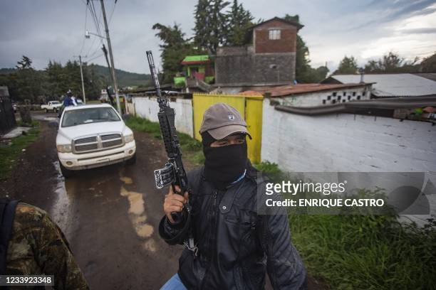 Members of the self-defense group Pueblos Unidos carry out guard duties in protection of avocado plantations, whipped by drug cartels that dominate...