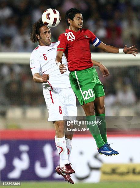 Iran's Ali Karimi and Indonesia's Bambang Pamungkas jump to head the ball during their 2014 World Cup Asian zone qualifying football match at Azadi...