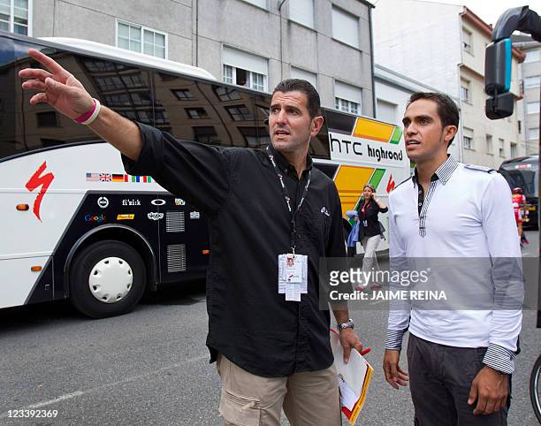 Spanish cyclist Alberto Contador and Technical Director Abraham Olano speak before the 13th stage of the Tour of Spain in Sarria, on September 2,...