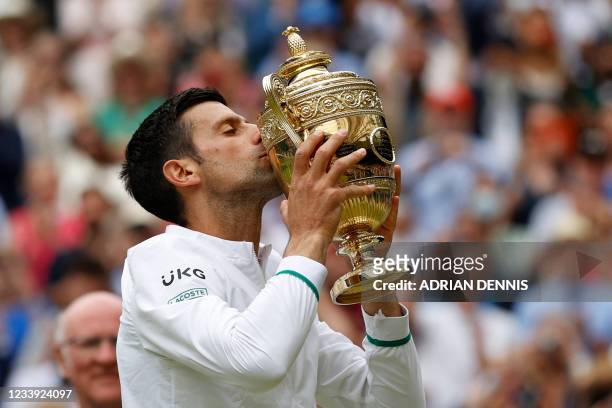 Serbia's Novak Djokovic kisses the winner's trophy after beating Italy's Matteo Berrettini during their men's singles final match on the thirteenth...