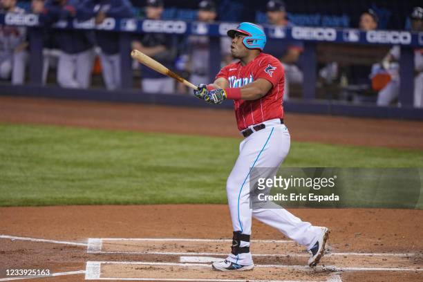 Jesus Aguilar of the Miami Marlins hits a home run in the first inning against the Atlanta Braves at loanDepot park on July 11, 2021 in Miami,...