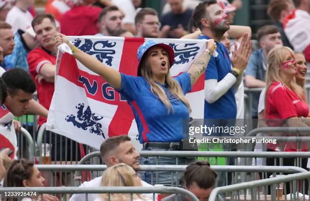 An England fan with a flag reacts to the UEFA Euro 2020 Championship Final between Italy and England, at the 4TheFans fan zone at Event City on July...