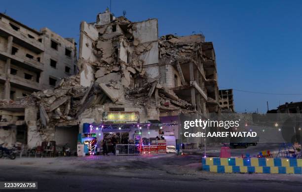 This picture shows Abu Ali's cafe, set up on the ground floor of a building heavily damaged during the civil war, in the Jabal al-Arbain hilltop...