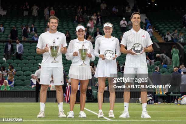 Winners Britain's Neal Skupski and US player Desirae Krawczyk and second place Britain's Joe Salisbury and Harriet Dart hold their trophies after the...