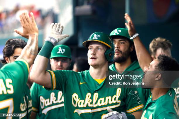 Sean Murphy of the Oakland Athletics celebrates with teammates after hitting a solo home run against the Texas Rangers during the second inning at...