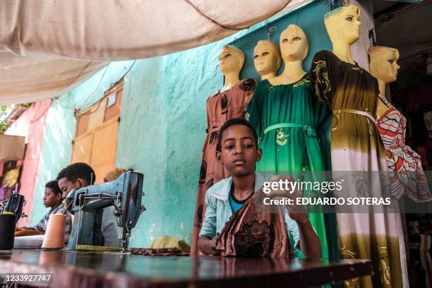 Boys work as tailors in a shop at the market in the city of Humera, in the northern Tigray Region, the last Ethiopian city south of the border with...