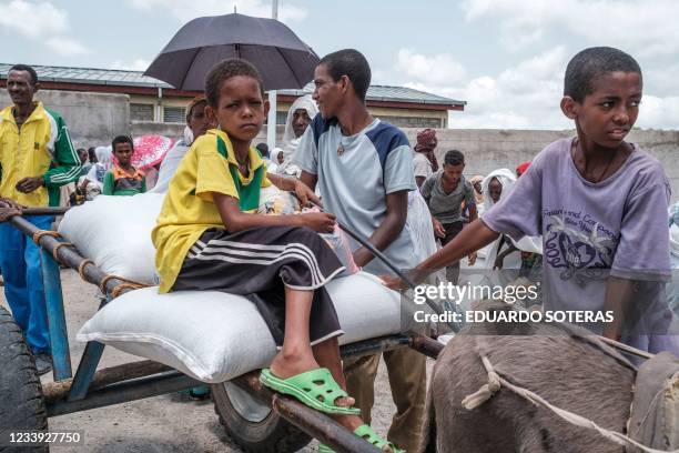 Children wait next to sacks of wheat during a food distribution organized by the Amhara government near the village of Baker, 50 km southeast of...
