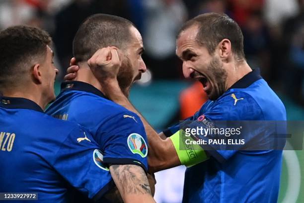 Italy's defender Leonardo Bonucci celebrates with Italy's defender Giorgio Chiellini after scoring the team's first goal during the UEFA EURO 2020...