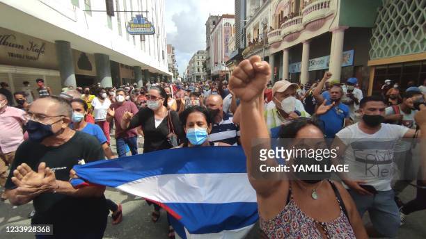 People take part in a demonstration to support the government of the Cuban President Miguel Diaz-Canel in Havana, on July 11, 2021. - Thousands of...