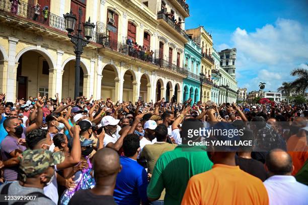 People take part in a demonstration against the government of Cuban President Miguel Diaz-Canel in Havana, on July 11, 2021. - Thousands of Cubans...