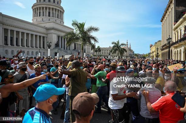 People take part in a demonstration against the government of Cuban President Miguel Diaz-Canel in Havana, on July 11, 2021. - Thousands of Cubans...