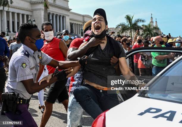 Man is arrested during a demonstration against the government of Cuban President Miguel Diaz-Canel in Havana, on July 11, 2021. Thousands of Cubans...