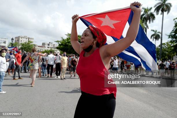 Pro-government woman is seen during a demonstration against the government of Cuban President Miguel Diaz-Canel in Havana, on July 11, 2021. -...