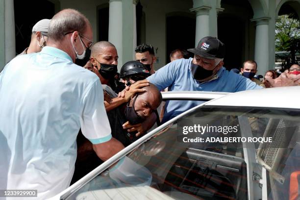 Man is arrested during a demonstration against the government of Cuban President Miguel Diaz-Canel in Havana, on July 11, 2021. - Thousands of Cubans...