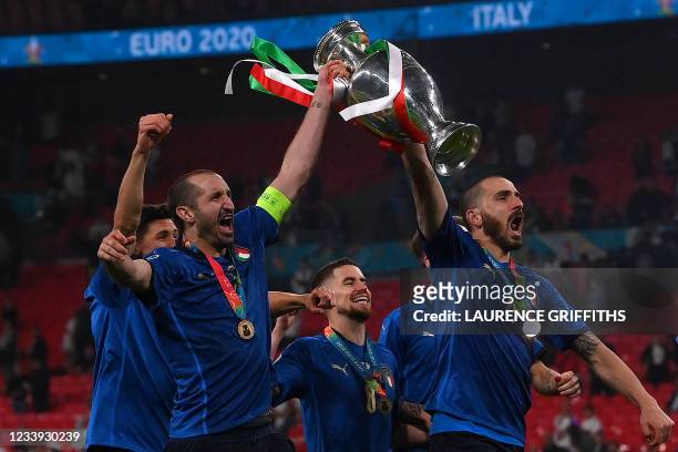 Italy's defender Giorgio Chiellini and Italy's defender Leonardo Bonucci pose with the European Championship trophy after Italy won the UEFA EURO...
